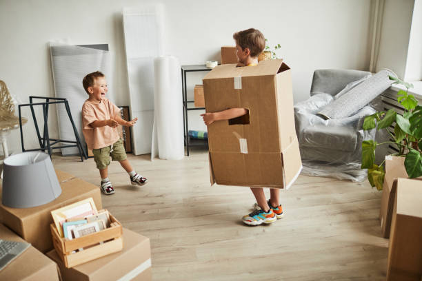 istock Boys in Boxes Playing in New House 1349049457