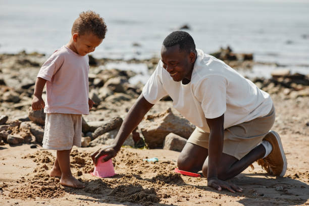 Father and Son Playing in Sand