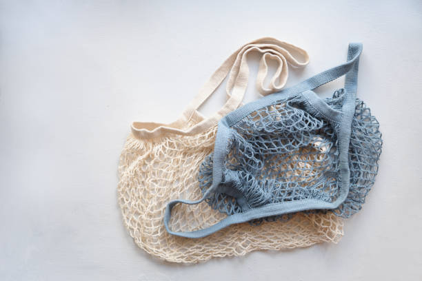istock two knitted mesh eco shopping bags on a light background, natural thread shoppers, eco friendly lifestyle, zero waste concept 1349061906