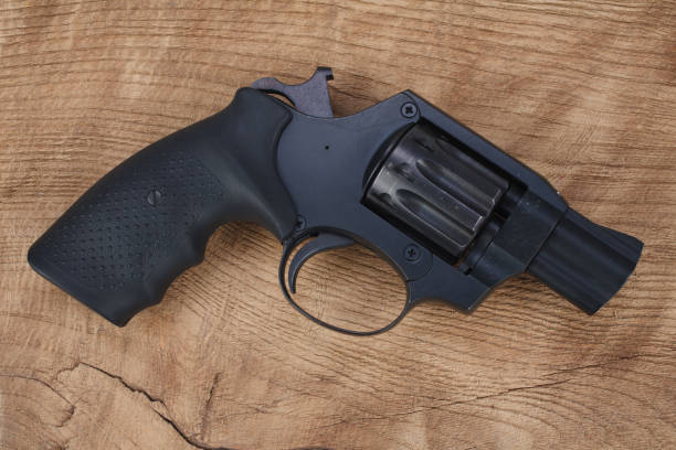 istock Cocked and locked revolver on wooden table 1349062996