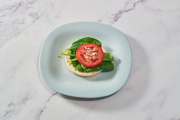Rice cakes with Spinach and tomatoes on top. Healthy food.