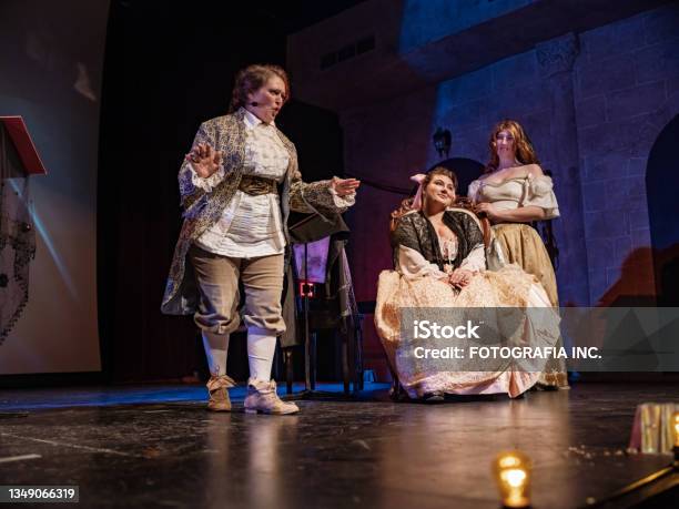 Three Actresses In Period Costumes On Theatre Stage Stock Photo - Download Image Now