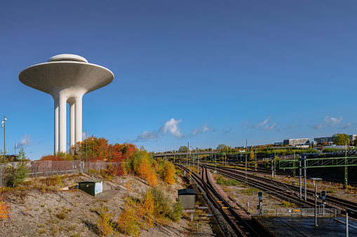 Malmo, Sweden - October 23, 2021: Hyllie water tower and railway tracks on a beautiful autumn day.
