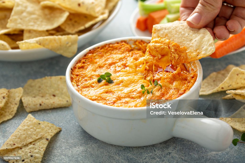 Buffalo chicken dip with chips Buffalo chicken dip served with chips and fresh vegetables Dipping Sauce Stock Photo