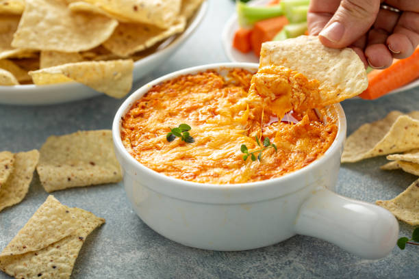 Buffalo chicken dip with chips Buffalo chicken dip served with chips and fresh vegetables dipping stock pictures, royalty-free photos & images