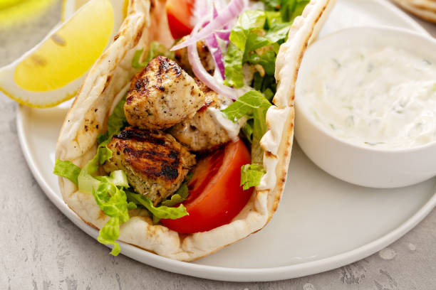 greek chicken souvlaki on wooden skewers - souvlaki imagens e fotografias de stock