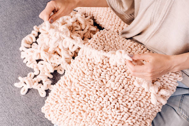Knits made from thick soft yarn. Soft knitted cushions made of thick yarn.