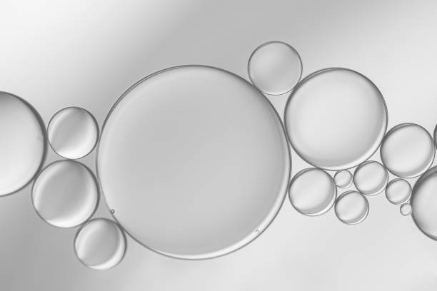 istock Oil droplets on water surface with silver-grey shadow background. 1349072281