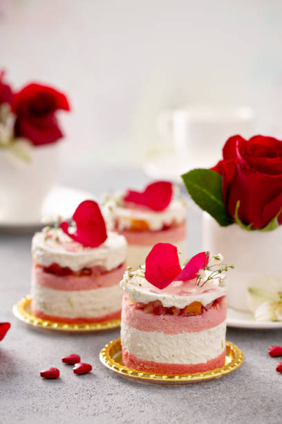 Light mousse cakes for Valentines Day Light mousse cakes for Valentines Day garnished with rose petals heart shape valentines day chocolate candy food stock pictures, royalty-free photos & images