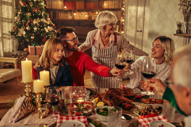 istock Joyful family celebrating Christmas at dining table. 1349076646