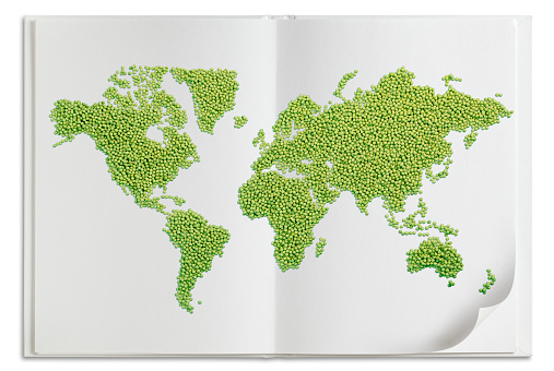 World map made of green peas isolated on white book