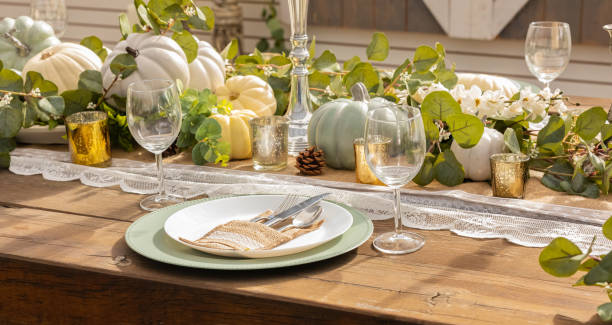 istock Autumn and Thanksgiving table decoration with white mini pumpkins 1349082606