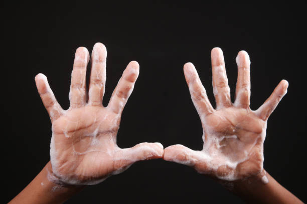 istock child boxy washing hands with soap isolated on black 1349084174
