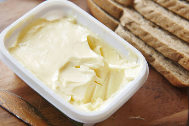 istock salted butter in a plastic container and breads on table 1349084960