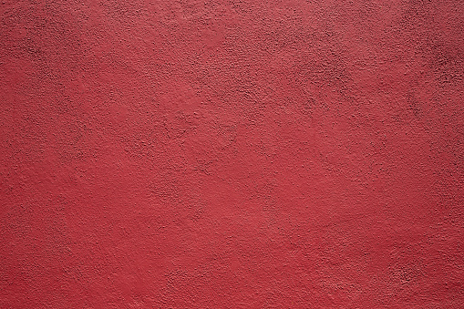 A view of a red stucco texture wall, as a background.