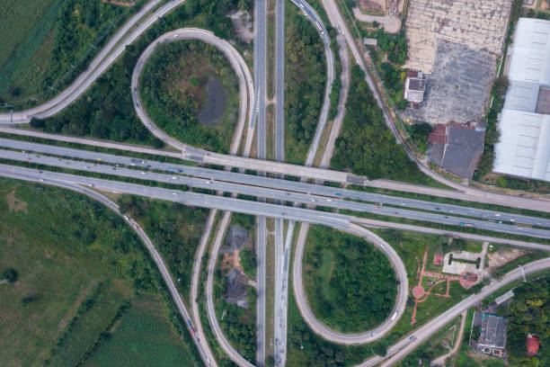 istock Aerial view of highway junctions with roundabout. Bridge roads shape circle in structure of architecture and transportation concept. Top view. Urban city, Bangkok at sunset, Thailand 1349090025