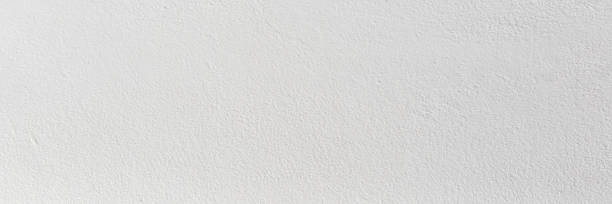 istock White color old grunge wall concrete texture as background, Wide banner. 1349094297
