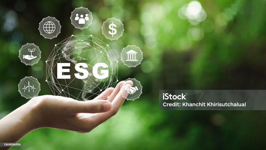 ESG icon concept in the hand for environmental, social, and governance in sustainable and ethical business on the Network connection on a green background. Environmental Social Corporate Governance - ESG Stock Photo