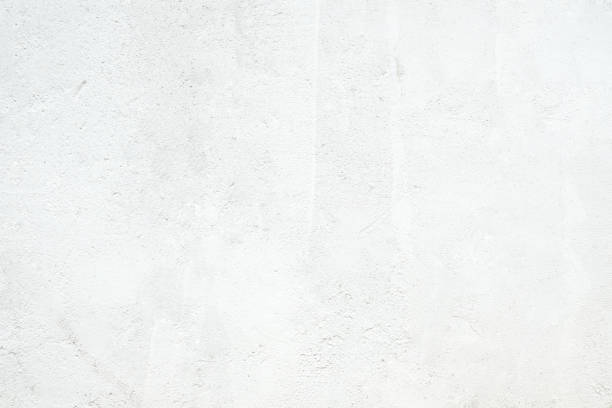 istock White concrete stone surface paint wall background, Grunge cement paint texture backdrop, White rough concrete stone wall background, Copy space for interior design background, banner, wallpaper 1349098487