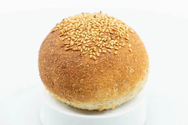 Detailed close up of a fresh baked individual wholemeal bread roll