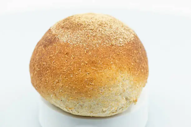 Detailed close up of a fresh baked individual wholemeal bread roll