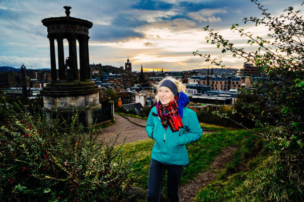 Mature women visiting Calton Hill at sunset on an autumn day in Edinburgh, Scotland.