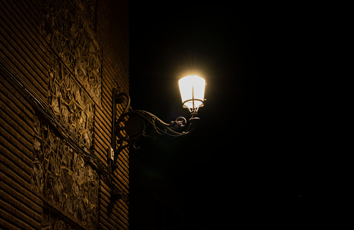 Street lamp on a brick wall at night