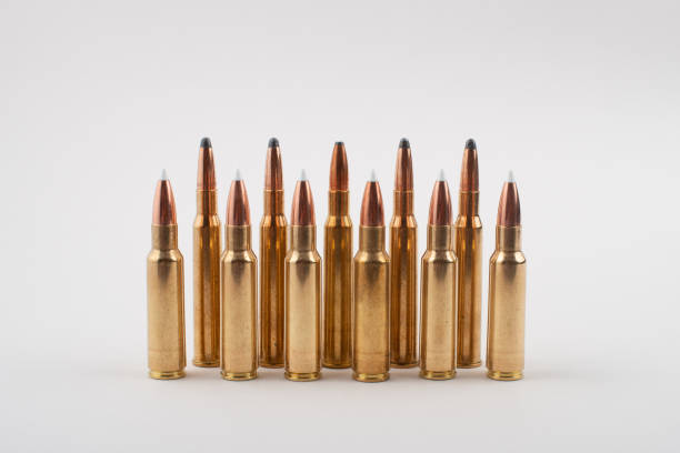 istock Rifle bullets in a row isolated on grey background. 1349106072