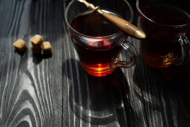 istock Warm tea with cane sugar in a home atmosphere under a blanket alone 1349107239