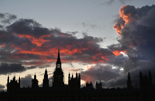 The outline of the Houses of Parliament against a dramatic sunset clouds. London, UK