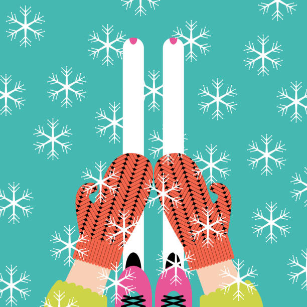 istock hands in bright knitted mittens catch beautiful white snowflakes and feet in ski boots 1349108297