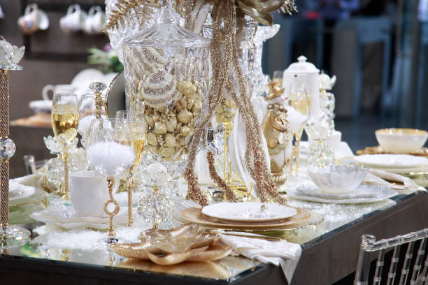 istock Festive xmas new year table setting with beautiful tableware and decor in shiny shining golden colors 1349108894