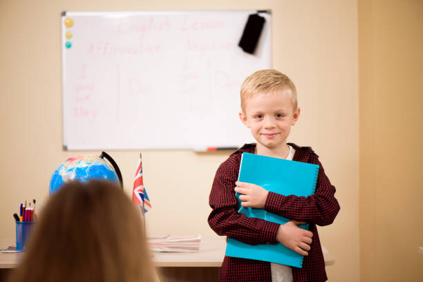 istock Portrait of a boy looking at camera in the classroom. 1349108980
