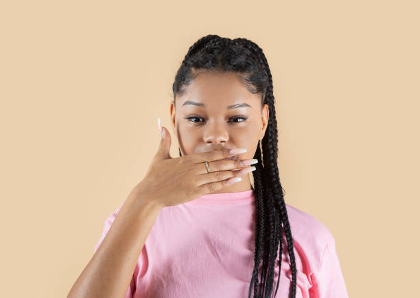 istock Latin woman covers her mouth with one hand 1349109318