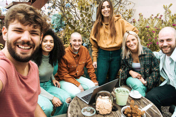 istock Group of happy young co-working students taking a memory selfie in the rooftop smiling and having fun together 1349111037