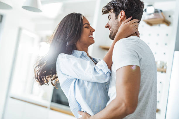 istock Happy loving couple talking during morning at kitchen. 1349111232
