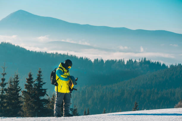 istock man walking by hill with snowboard 1349111348