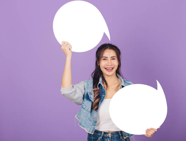 istock woman smiling excited wear denims hold empty speech bubble sign 1349112670