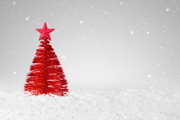 istock Red tree shape Christmas Decoration on a fake snow background 1349112778