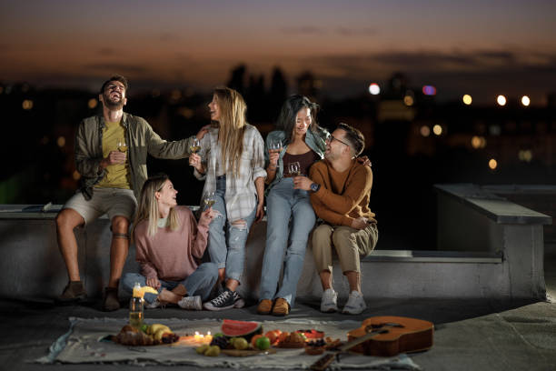 istock Cheerful friends having fun during party night on a roof. 1349112978