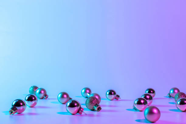 Christmas balls neon winter background. Xmas bauble on abstract holiday gradient backdrop. Happy new year copy space.