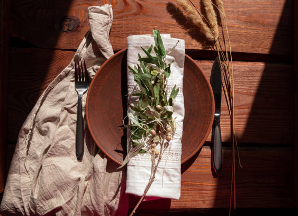 istock Empty craft handmade clay plate with fork knife on tablecloth. Table place hand crafted dish Natural home interior decor 1349114305