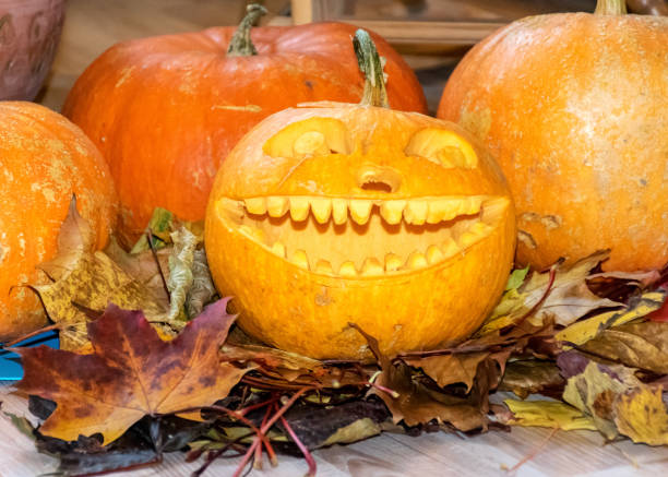istock orange halloween pumpkin with carved traditional face, 1349114938