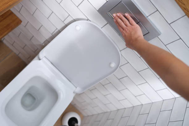 istock A hand presses the toilet bowl flush, close-up 1349116660