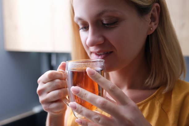 istock Pensive woman drinking hot tea from a cup 1349117426
