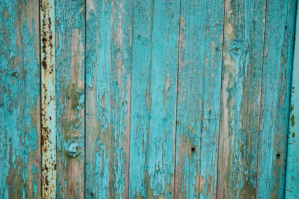 istock An old wooden wall with peeling paint. Beautiful textured background. Close-up 1349117549