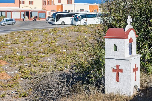 Kandylakia (Roadside Shrine) in Pyrgos Kallistis on Santorini, Greece , with vehicles visible in the background. These are usually erected for lives both lost or saved on the roadside.