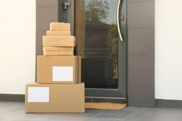 istock Cardboard boxes near door. Parcel delivery service 1349121400