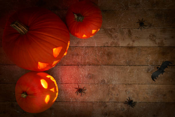 istock glowing pumpkins on a dark wooden cobweb background 1349121512