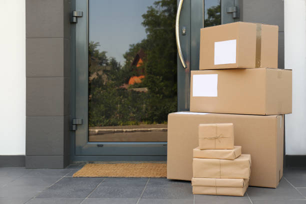istock Cardboard boxes near door. Parcel delivery service 1349121543